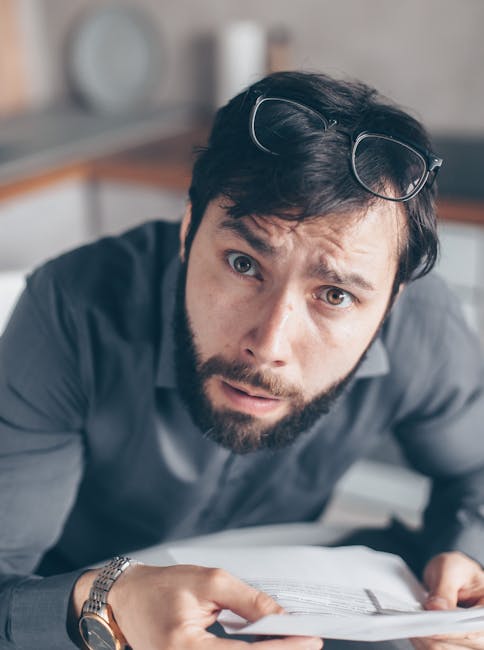pexels photo 7534777 7534777 Portrait of an astonished man with a beard holding documents inside an office.